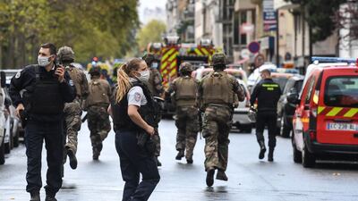 French army soldiers rush to the scene after several people were injured near the former offices of the French satirical magazine Charlie Hebdo on Saturday. AFP