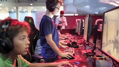 Gamers enjoy the video games on offer at the 2018 Middle East Games Con. Antonie Robertson / The National