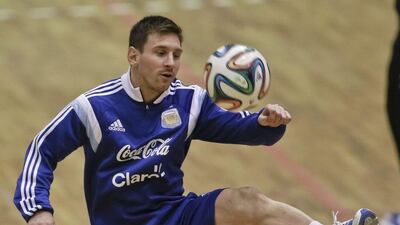 Lionel Messi juggles the official 2014 World Cup ball during Argentina's training session for an international friendly v Romania. Vadim Ghirda / AP