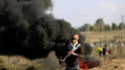 Tear gas hits a Palestinian protester during clashes with Israeli security forces near Gaza City on October 30, 2015. Palestinians have staged a series of Day of Rage rallies against Israeli authorities. Mohammed Abed/AFP