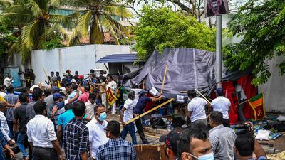 Demonstrators and government supporters clash outside the official residence of Mahinda Rajapaksa, 76, who offered his resignation to his younger brother, President Gotabaya Rajapaksa. AFP