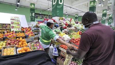 A shopper buys vegetables at Deira Waterfront Market in Dubai