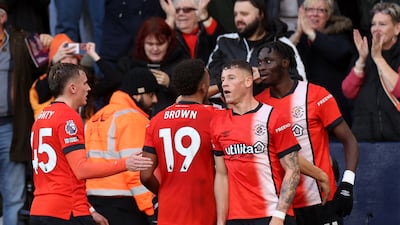 Luton Town's Elijah Adebayo, far right, celebrates with teammates after scoring their first goal. Reuters