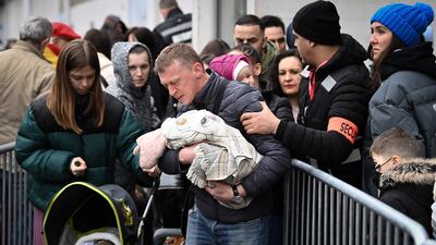 Ukrainians queue outside a refugee centre in Paris. AFP