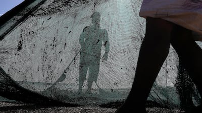 Fishermen arrange a fishing net for the next catch