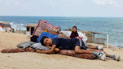 Displaced Palestinian children fleeing northern Gaza due to an Israeli military operation rest as they move southwards after Israeli forces ordered residents of Gaza city to evacuate to the south, in the central Gaza Strip. Reuters