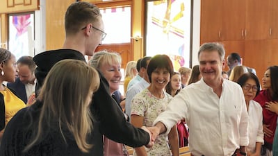 People greet each other a merry Christmas during the Christmas Day service.