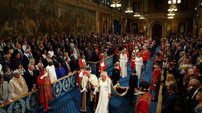 King Charles and Queen Camilla proceed through the Royal Gallery at the Houses of Parliament. AFP