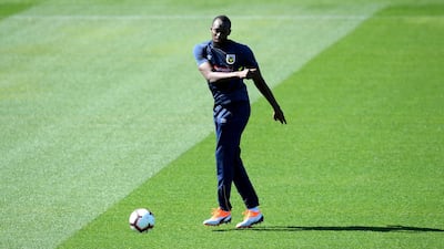 Usain Bolt passes the ball as he is put through his paces. EPA