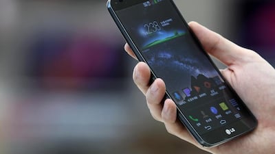 An employee demonstrates an LG G Flex curved smartphone at the company's store in Seoul, South Korea. SeongJoon Cho / Bloomberg