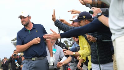 Marc Leishman celebrates with fans after his shot on the 18th hole. Getty