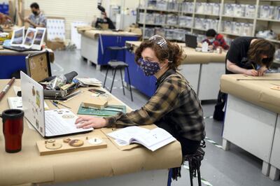 Film and television students work in a Covid-secure classroom at the University of Bolton. AFP
