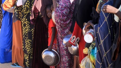 Sudanese women line up for food at Al Afad camp for displaced people in Al Dabba, northern Sudan, on November 20. AFP