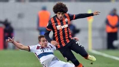 Bayern's Rafinha mistimes a sliding tackle on Taison. Sergei Supinsky / Getty