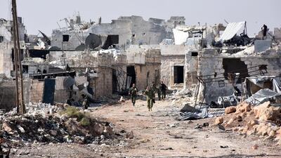 Syrian pro-government forces walk around in the village of Minyan, west of Aleppo, after they retook the area from rebel fighters George Ourfalian /AFP