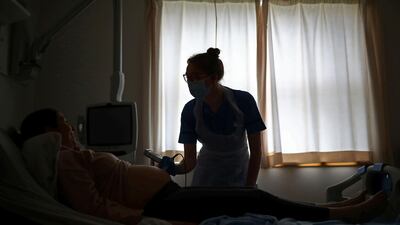 Midwife Victoria Oldfield (R) checks the heartbeat of Laura Finney's unborn baby on the antenatal ward at the Lancashire Women and Newborn Centre at Burnley General Hospital in Burnley, north-west England on May 15. Hannah Mckay / AFP / Pool