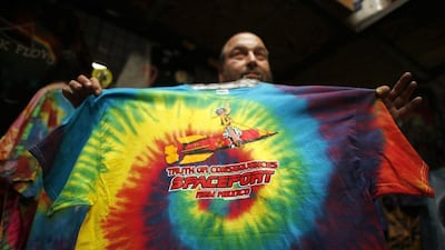 Jeff Dukatt displays a tie-dyed spaceport T-shirt he made at his store in Truth or Consequences, New Mexico. While it’s not clear what the economic impact will be, many agree that Spaceport America should inject new energy into the town. Lucy Nicholson / Reuters