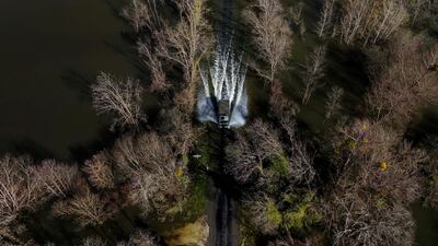 A French gendarmerie vehicle takes residents out of the flood-isolated village of Courcoury, south-western France. AFP