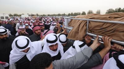 Mourners attend the funeral of a Kuwaiti and a Saudi citizen residing in Kuwait, two days after their bodies were found in a desert area in western Iraq, at a cemetery in Kuwait City. AFP