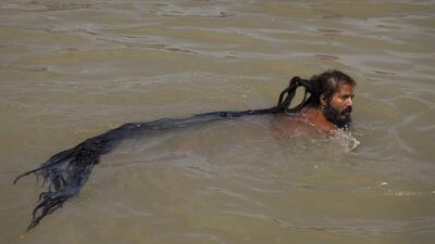 An Indian Sadhu, or Hindu holy man, takes a bath in the Godavari River. Tsering Topgyal / AP
