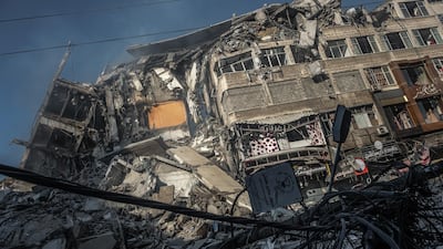 Smoke rises from the rubble of Al-Shorouk Tower in Gaza city. Getty Images