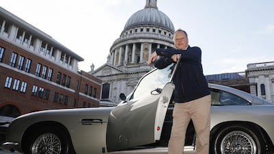 Andy Palmer, chief executive of Aston Martin, with an original DB5 in London. The company is set to replace Mr Palmer who joined the company in 2014. Bloomberg