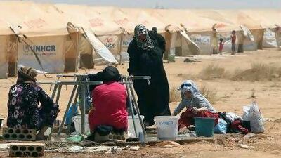 Syrian refugees wash clothes at Al Zaatri refugee camp in the Jordanian city of Mafraq, near the border with Syria. Thousands have been forced to flee, while other civilians remain trapped by the fighting.