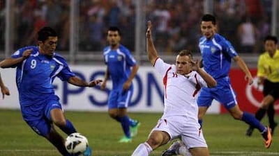Uzbekistan's Odil Ahmedov, left, challenges Jordan's Oday Zahran for the ball. With both sides chasing a first appearance at the World Cup finals host Jordan drew 1-1 with Uzbekistan. The next leg will be Tuesday at Tashkent.