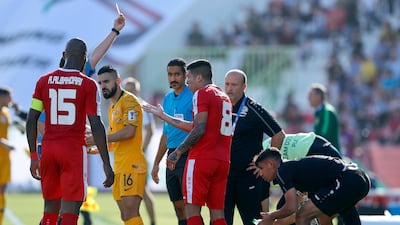 Palestine's Jonathan Zorrilla gets a yellow card. AP Photo