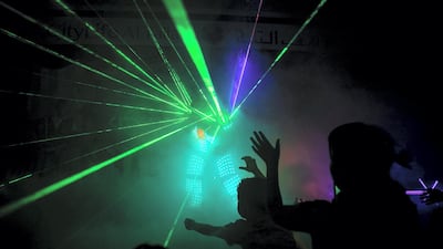 Light is a big part of Al Dhaheri's show; his costume is studded with red and green bulbs, while powerful lasers dominate the background. Photo: Reem Mohammed / The National