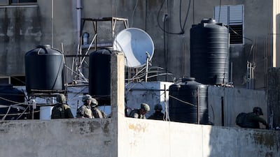 Israel soldiers prepare explosive devices to demolish the house of Palestinian prisoner Abdul Karim Sanoubar in Zawata, near the occupied West Bank city of Nablus. All Photos: EPA
