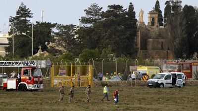 Rescue services at the scene of a light aircraft crash at the airport in Valletta, Malta. Darrin Zammit-Lupi / Reuters