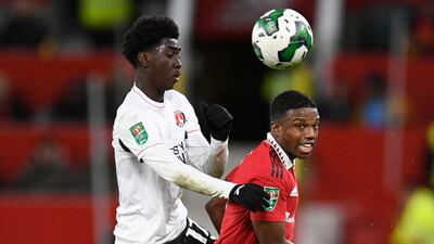 United's Dutch defender Tyrell Malacia battles with Charlton's Jesurun Rak-Sakyi. AFP