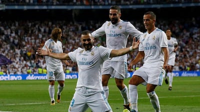 Karim Benzema celebrates scoring Real Madrid’s second goal with his teammates. Juan Medina / Reuters