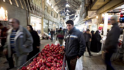 An Iranian vendor sells pomegranates at Tehran's main bazaar on January 2. Maryam Rahmanian for The National
