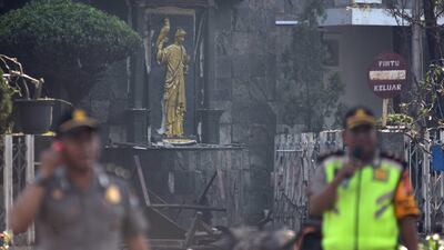 Police are seen outside the Immaculate Santa Maria Catholic Church following a blast, in Surabaya, East Java, Indonesia. Reuters