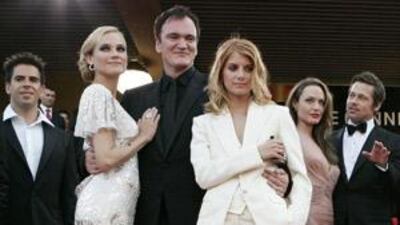 The director Quentin Tarantino, surrounded by some cast members of Inglorious Basterds at Cannes, where the film received mixed reviews - something that hasn't changed since its widespread release in cinemas.