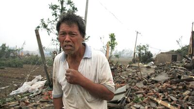 A man stands on debris of his damaged house after a tornado hit Funing county, Yancheng, Jiangsu province, China on June 23, 2016. China Daily/ Reuters