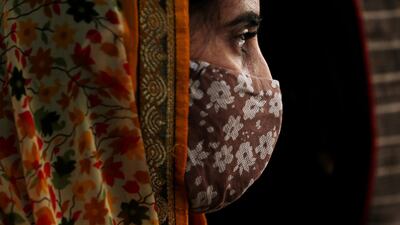 epa09139376 A woman wears a protective face mask in Bangalore, India, 16 April 2021. India recorded massive surge of 217,353 fresh Covid-19 cases, the highest single-day spike in COVID-19 infections. India is seeing a second wave of the virus which has led several states including Maharashtra and the capital, New Delhi and Bangalore to impose night curfew and new restrictions. EPA/JAGADEESH NV