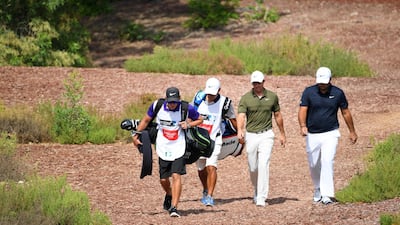 DUBAI, UNITED ARAB EMIRATES - NOVEMBER 16: Rory McIlroy of Northern Ireland and Patrick Reed of the United States walk off the 2nd tee during day two of the DP World Tour Championship at Jumeirah Golf Estates on November 16, 2018 in Dubai, United Arab Emirates. (Photo by Ross Kinnaird/Getty Images)