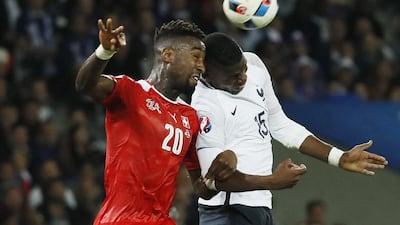 Switzerland defender Johan Djourou challenges France midfielder Paul Pogba for the ball. Gonzalo Fuentes / Reuters