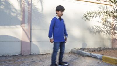 Zayed, 9 plays on a motor board around the Mushrif residential area outside his house in Abu Dhabi. Mona Al Marzooqi/ The National