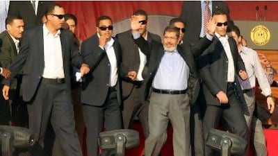 Egypt's president-elect Mohammed Morsi greets the crowd at Tahrir Square Friday. He will be officially sworn in as president Saturday.
