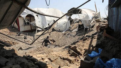 A man inspects the damage at a site hit by an Israeli air strike in Khan Younis in the southern Gaza strip. Mahmud Hams / AFP Photo