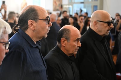 Oussama Rahbani, left, with his brothers Ghadi and Marwan, attends the funeral of Ziad Rahbani in July. AFP
