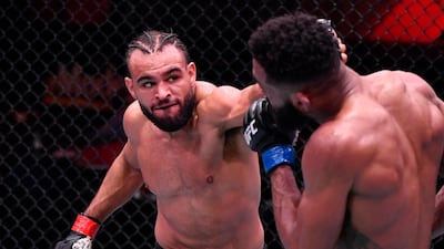 Gabe Green punches Phil Rowe in their welterweight fight during the UFC 258 event at UFC APEX in Las Vegas, Nevada. Jeff Bottari / Zuffa LLC / UFC