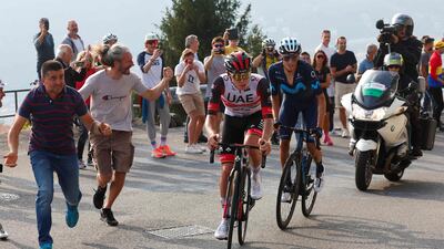 Fans cheer from the road as Tadej Pogacar and Enric Mas (R) ride during the 116th edition of the Giro di Lombardia. AFP