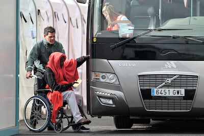 A newly arrived migrant prepares to board a bus in La Restinga, on the Canarian island of El Hierro, Spain. EPA
