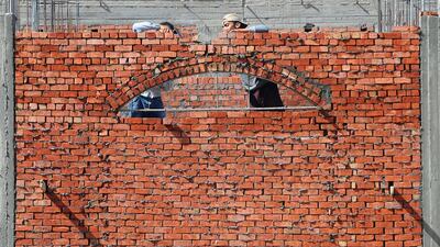 Construction workers are seen at new houses on the outskirts of Cairo, Egypt. Reuters