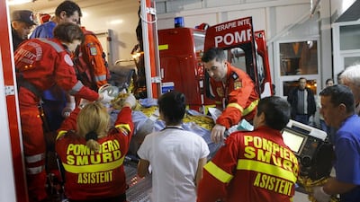 A woman on a stretcher, who survived a fire at a club, is taken to a hospital in Bucharest, Romania, early on October 31.EPA